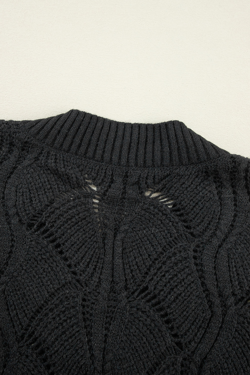 Schwarzer strickpullover mit v-ausschnitt und hohlen schultern