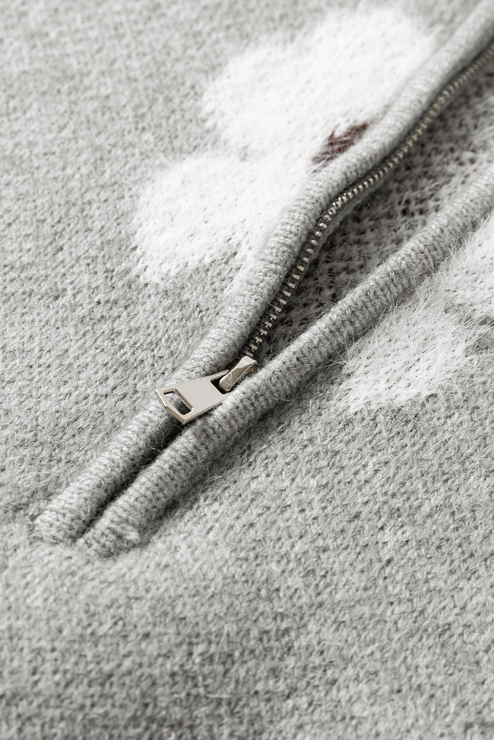 Grauer pullover mit floralem muster und halbem reißverschluss an der schulter