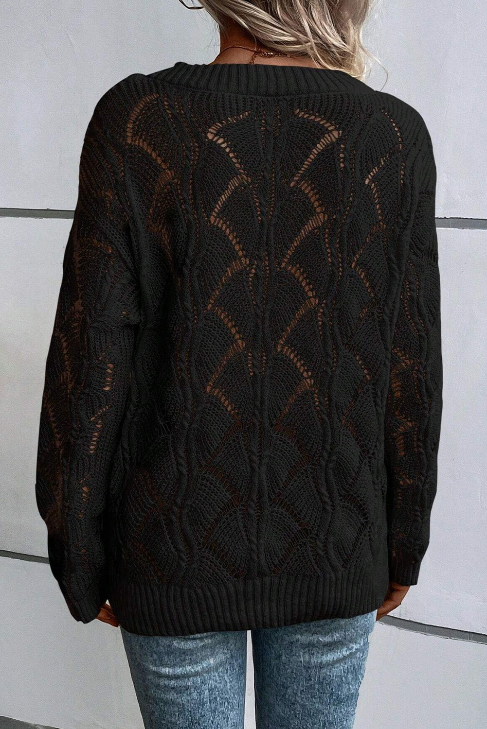 Schwarzer strickpullover mit v-ausschnitt und hohlen schultern