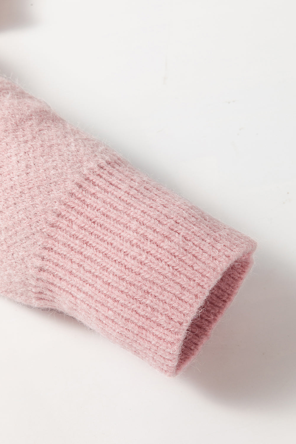 Rosafarbener pullover mit blumenmuster und halbem reißverschluss an den schultern