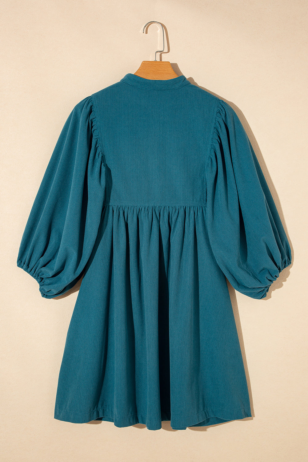 Blaues cord-knopf-kleid mit empire-taille und armband-ärmeln