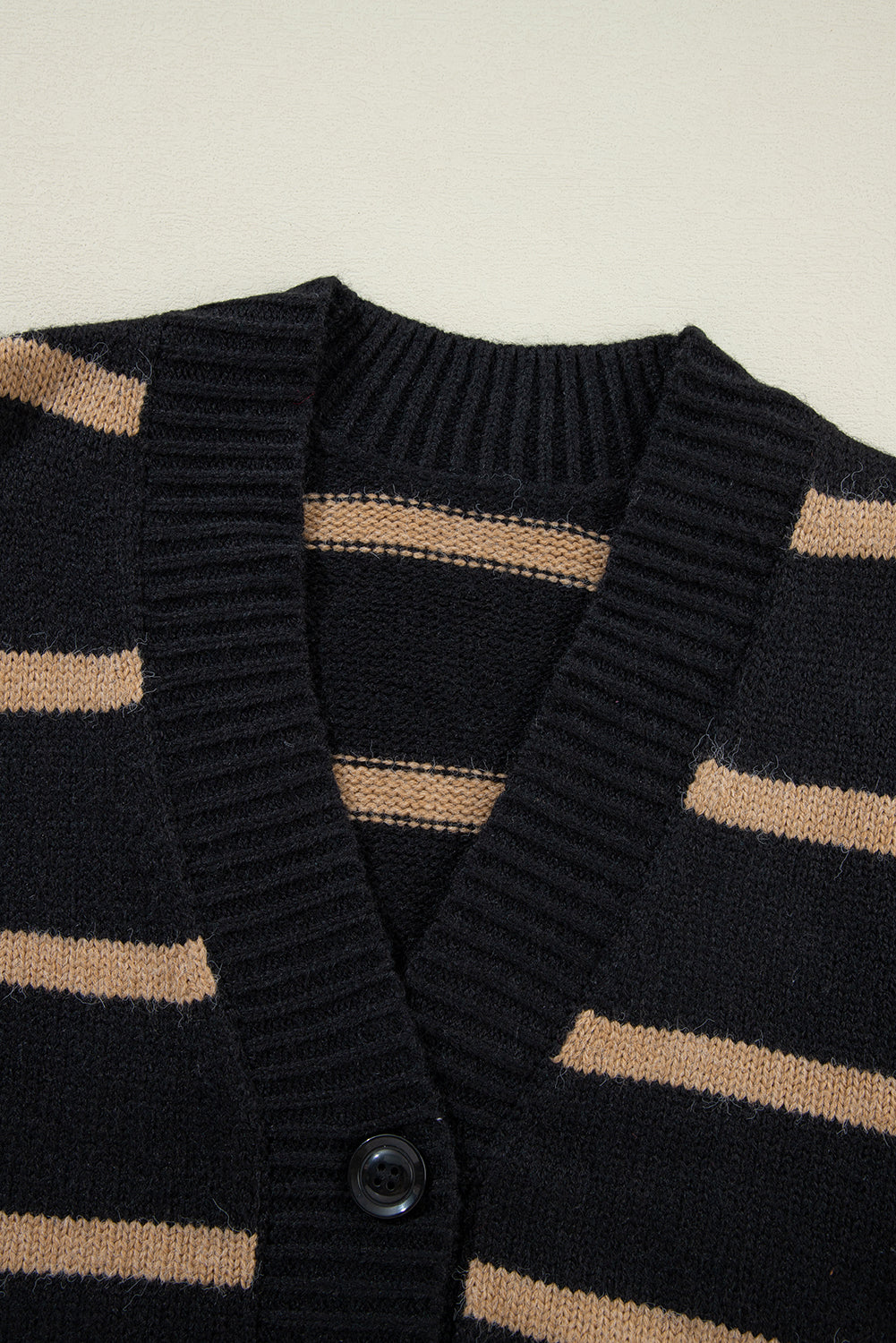 Schwarzer gestreifter, geknöpfter v-ausschnitt, lockere strickjacke mit hängenden schultern