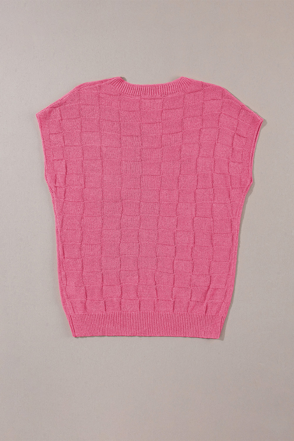 Leuchtend rosafarbener strickpullover mit kurzen ärmeln und gitterstruktur