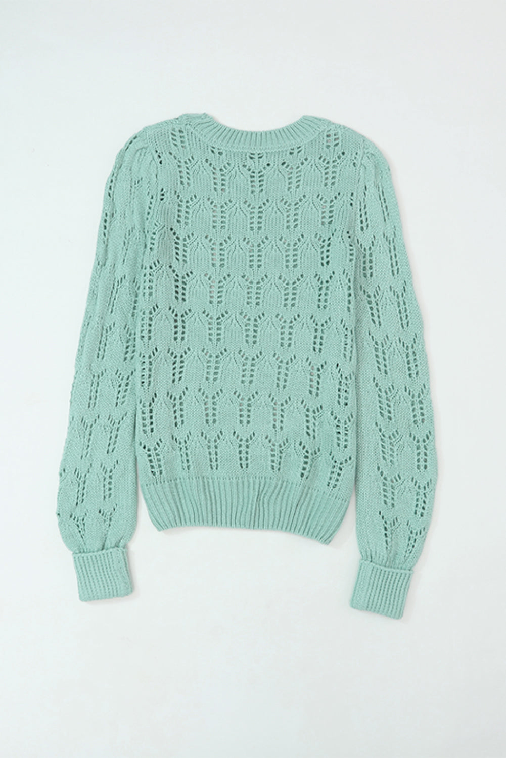 Grüner pointelle-pullover aus transparentem strick