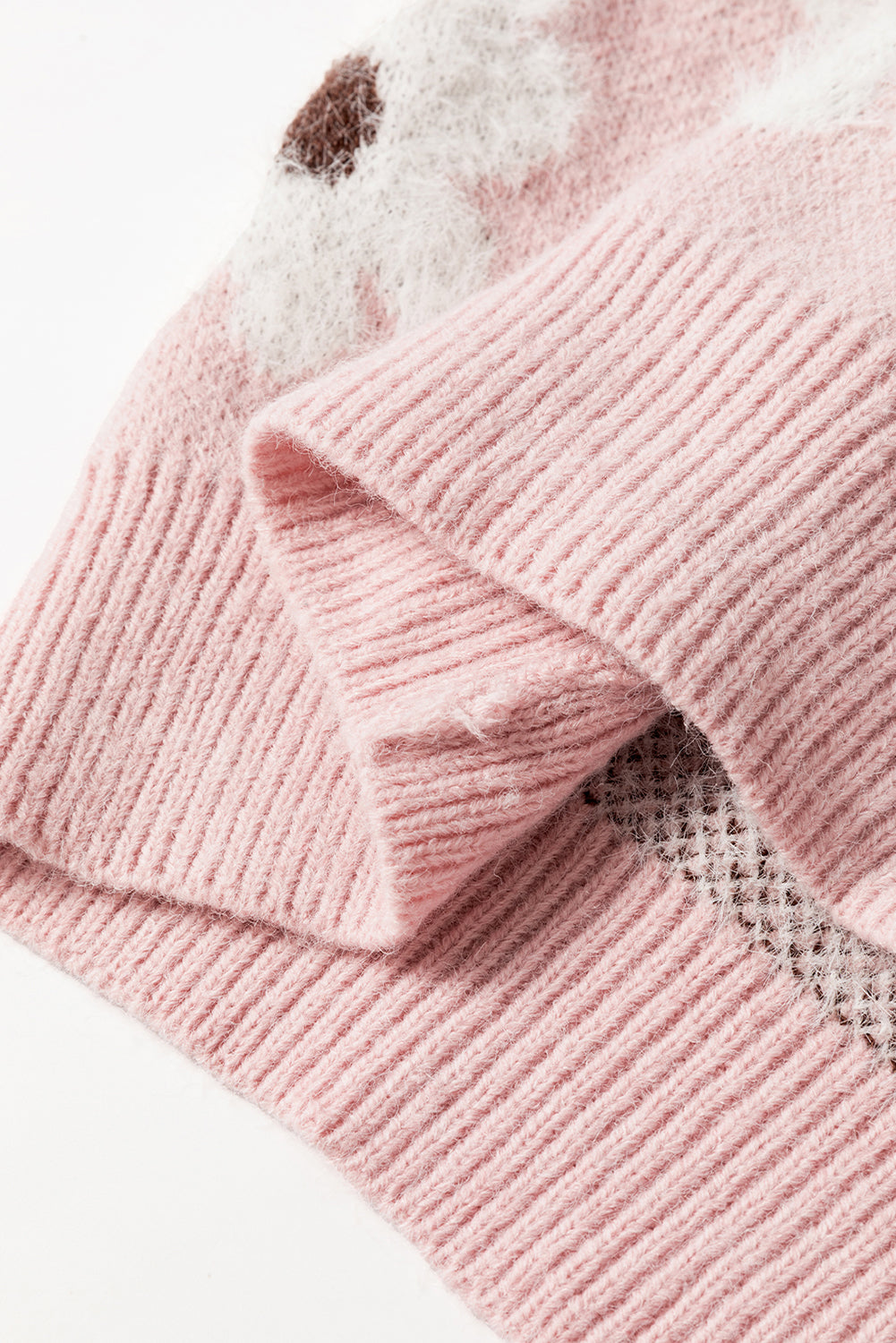 Rosafarbener pullover mit blumenmuster und halbem reißverschluss an den schultern