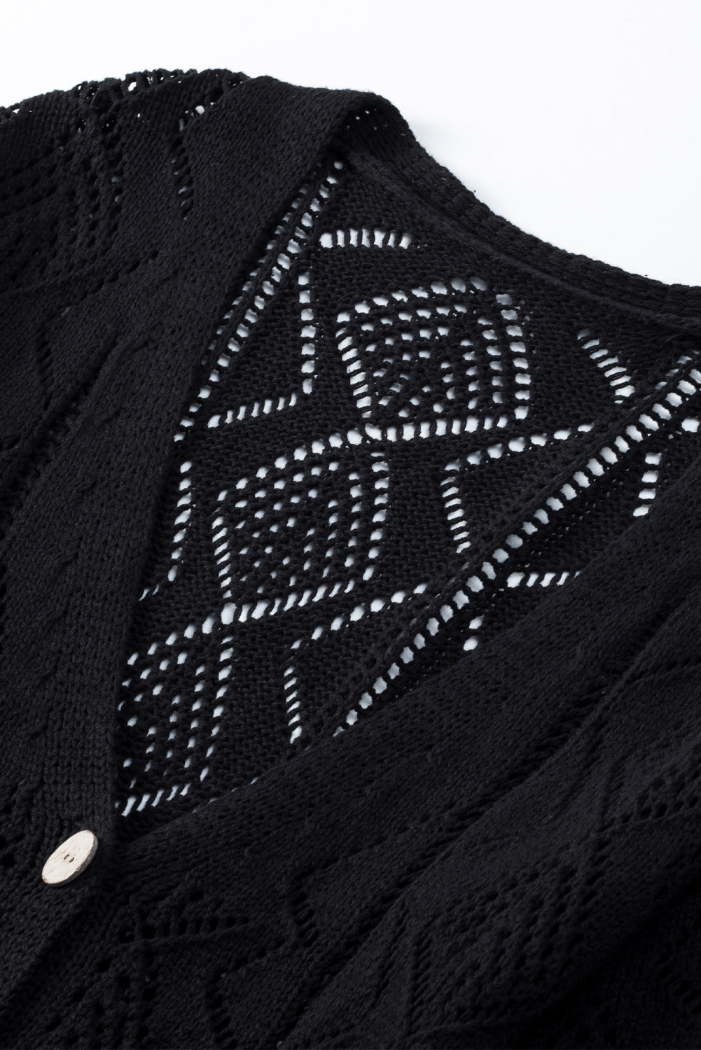 Schwarze durchbrochene strickjacke mit lochmuster