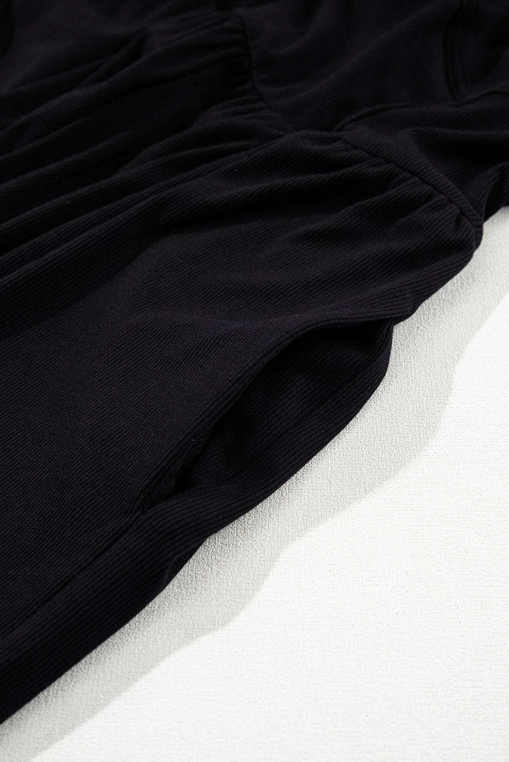 Schwarzer ärmelloser jumpsuit mit weitem bein und eingeschnürter taille