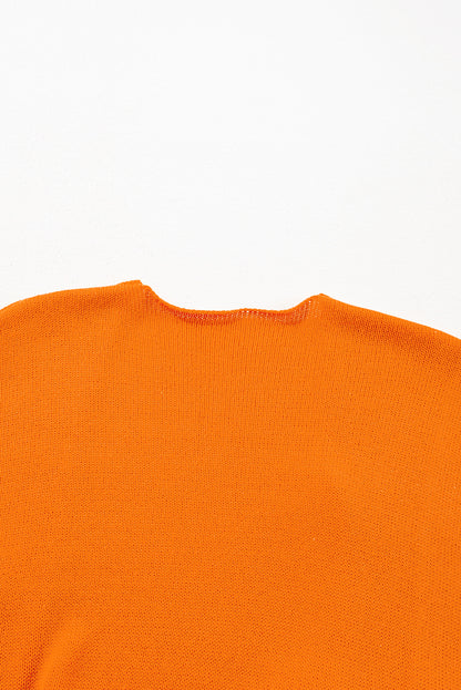 Orangefarbene strickjacke mit blumendruck und offener vorderseite