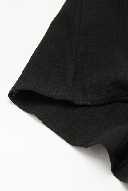 Schwarzes gefaltetes minikleid mit kurzen ärmeln und v-ausschnitt