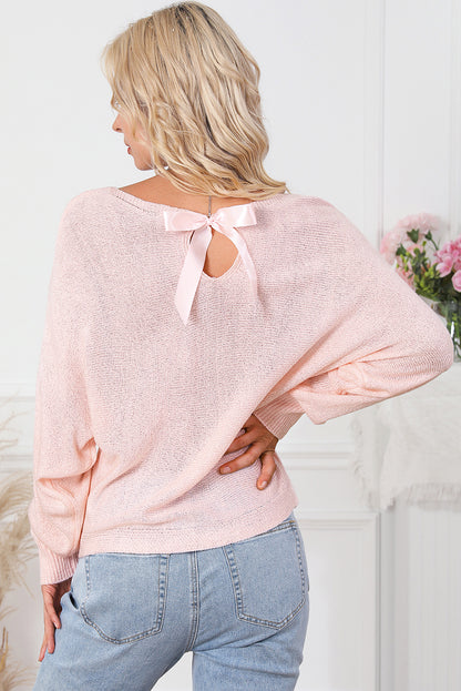 Pullover mit rosa schleifenknoten und dolman-ärmeln