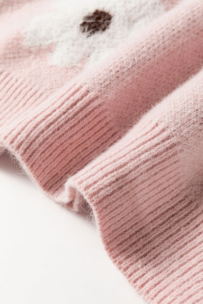Rosafarbener pullover mit blumenmuster und halbem reißverschluss an den schultern