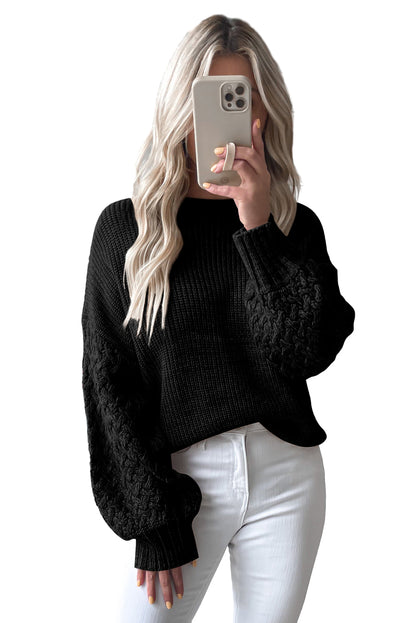 Schwarzer pullover mit zopfstrickärmeln und hängeschultern