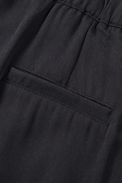 Schwarze plissierte elegante hose mit weitem bein