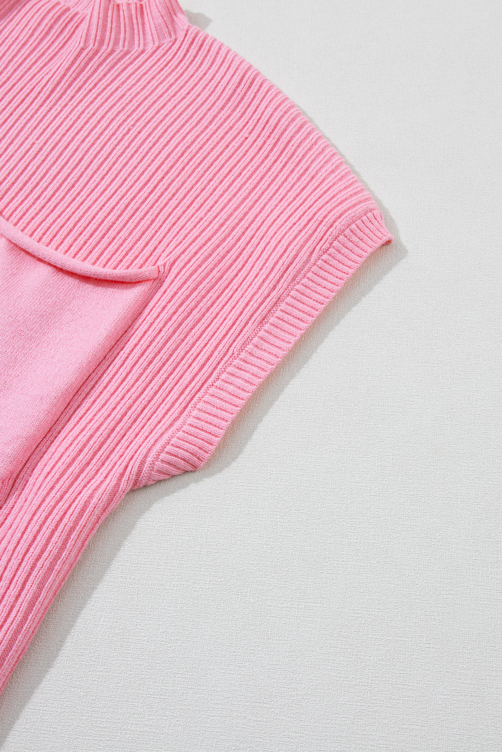 Rosafarbener kurzarmpullover mit aufgesetzten taschen aus rippenstrick