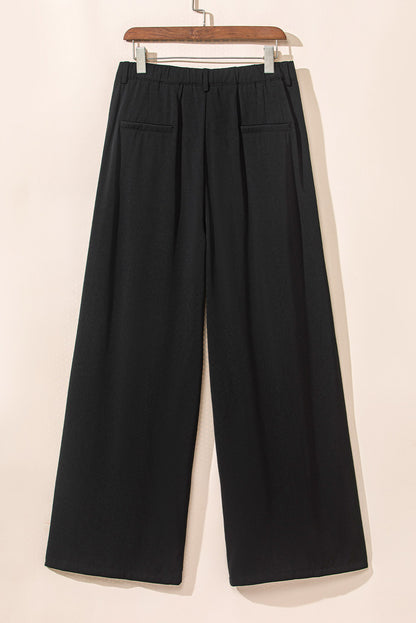 Schwarze plissierte elegante hose mit weitem bein