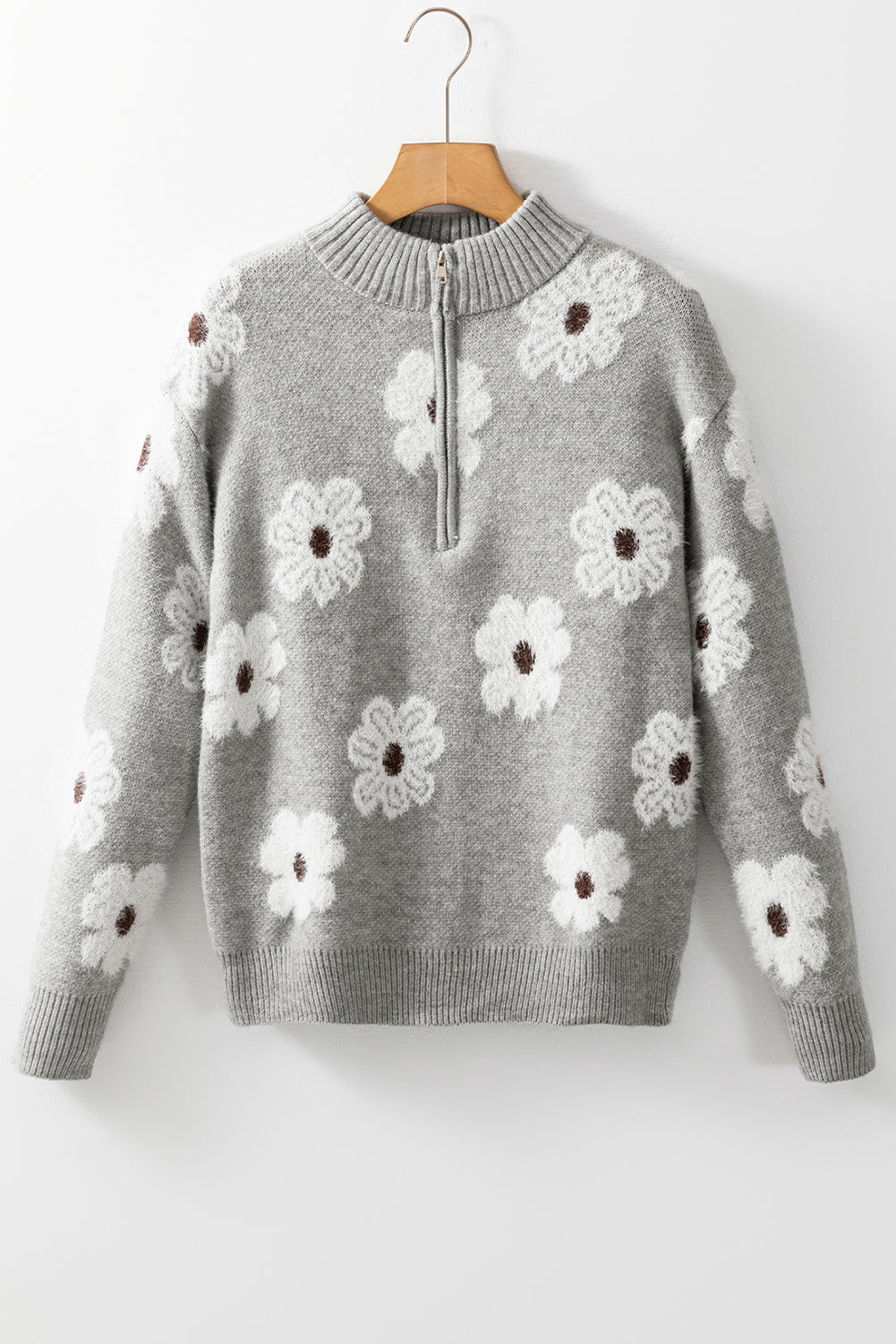Grauer pullover mit floralem muster und halbem reißverschluss an der schulter
