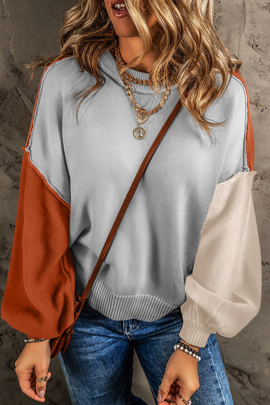 Grauer colorblock-pullover mit gerippten ärmeln und zierleisten