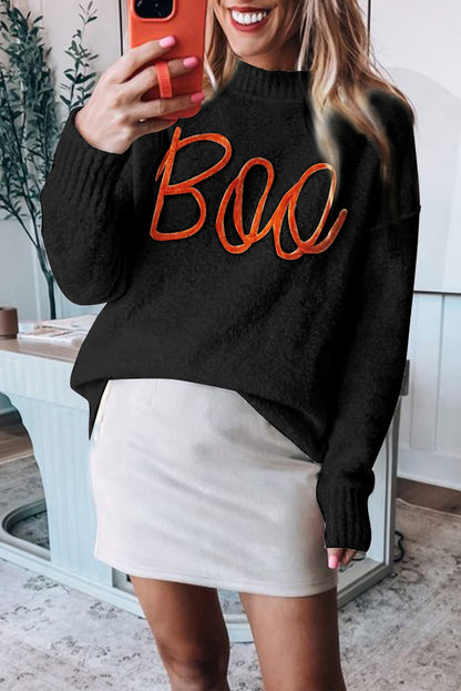 Schwarzer boo strickpullover mit geripptem rand und schultern