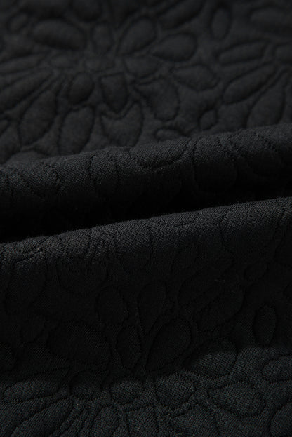 Schwarze gesteppte jacke mit blumenmuster