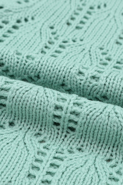 Grüner pointelle-pullover aus transparentem strick