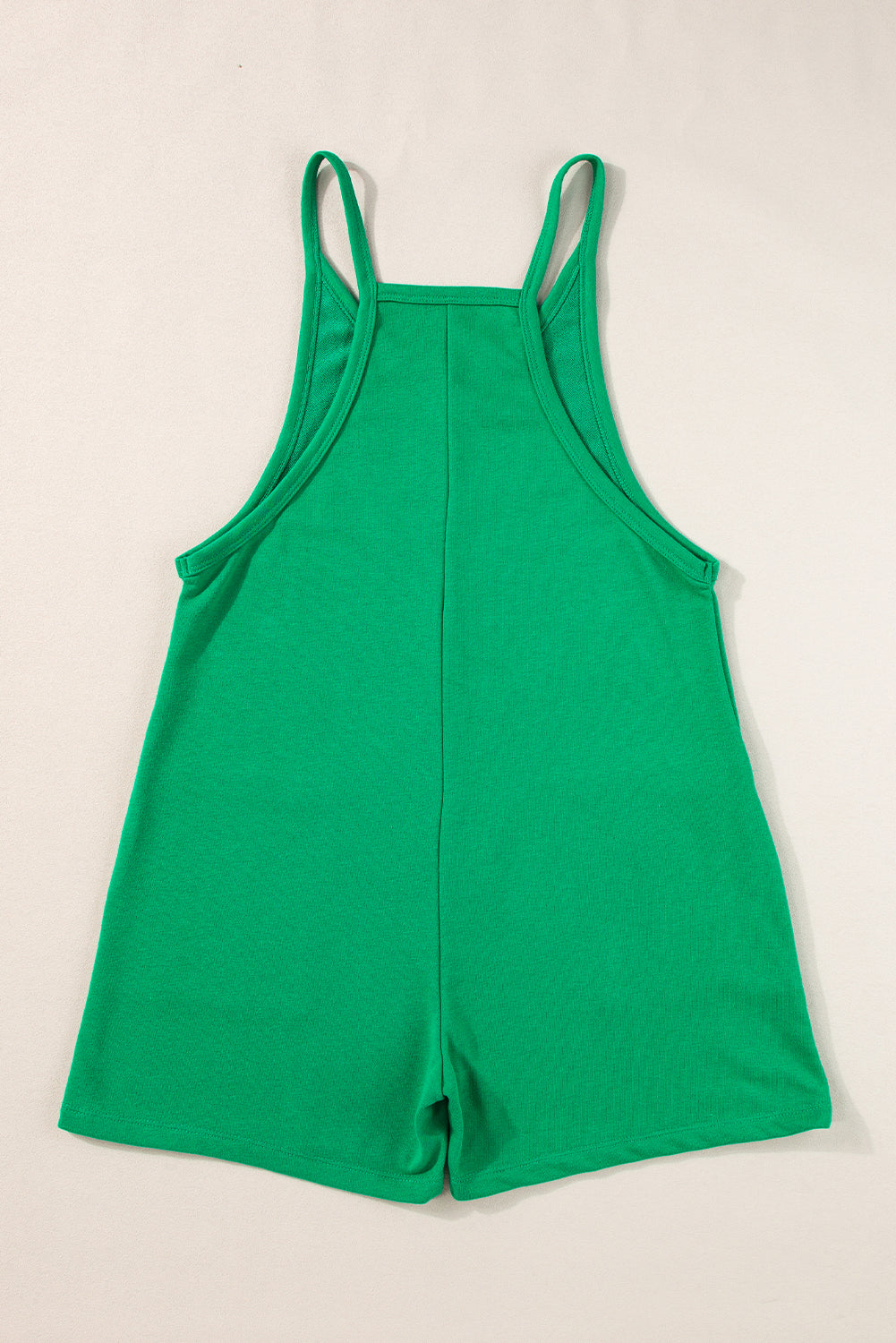 Hellgrüner ärmelloser jersey-strampler mit v-ausschnitt und taschen