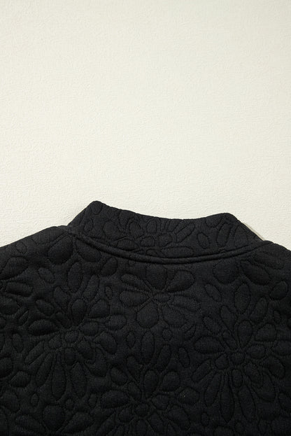 Schwarze gesteppte jacke mit blumenmuster