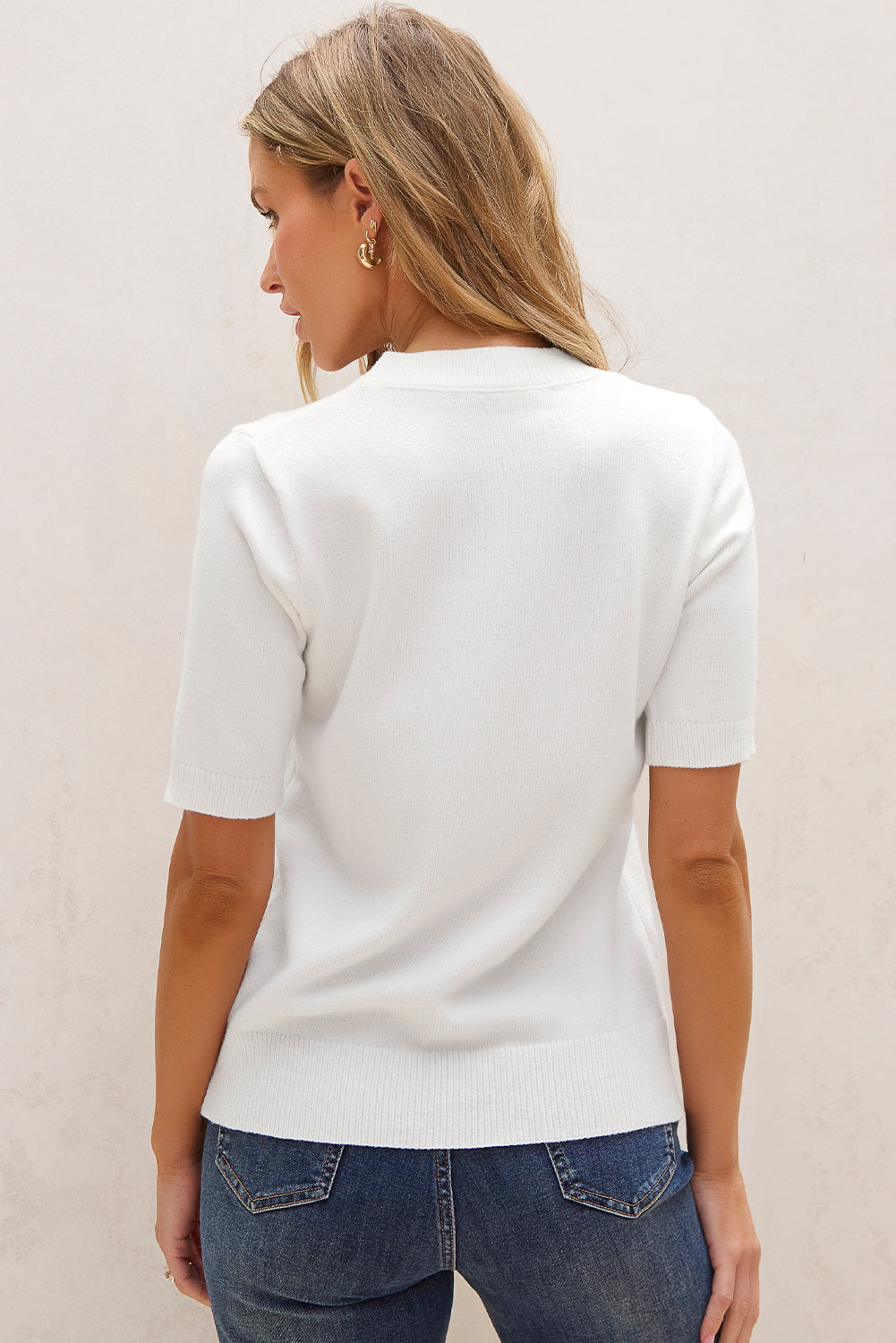 Weißer kurzarm-pullover mit niedlichen blumenapplikationen