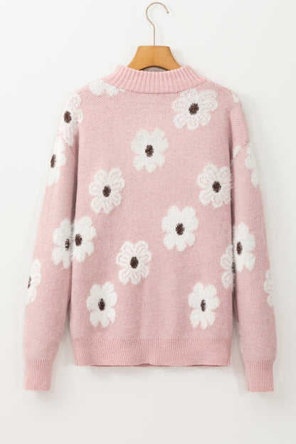Rosafarbener pullover mit blumenmuster und halbem reißverschluss an den schultern