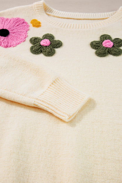 Beige gestrickter pullover mit blumenmuster und geripptem rand