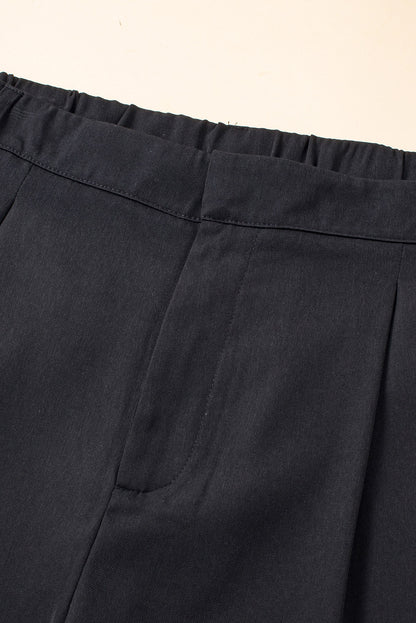Schwarze plissierte elegante hose mit weitem bein