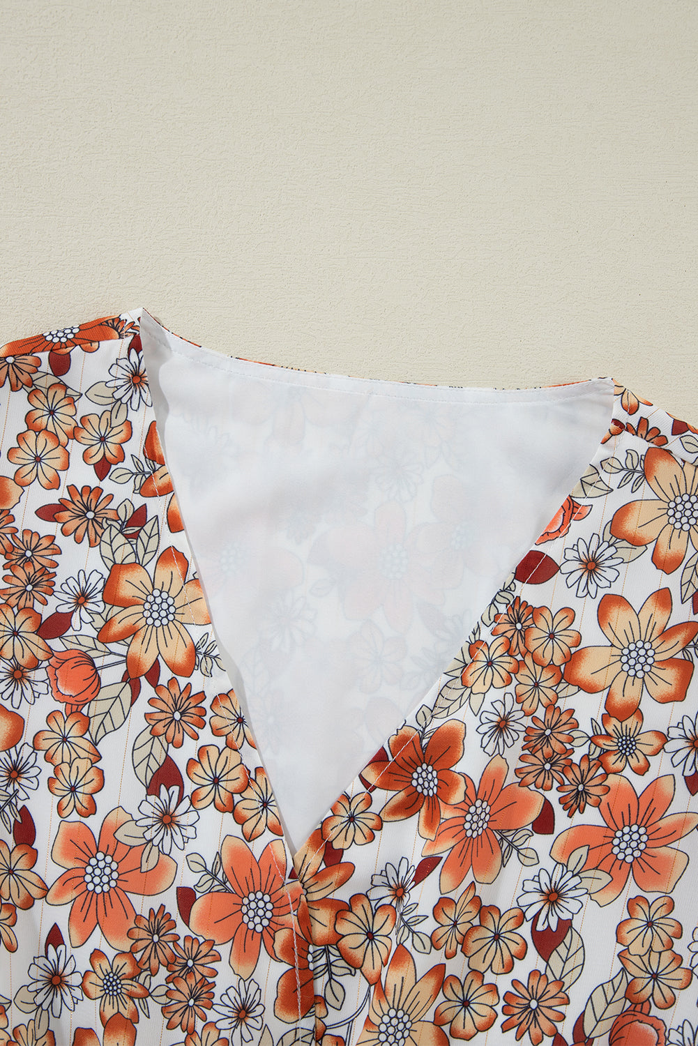 Khakifarbenes langarm-midikleid mit blumenmuster und gerafftem v-ausschnitt