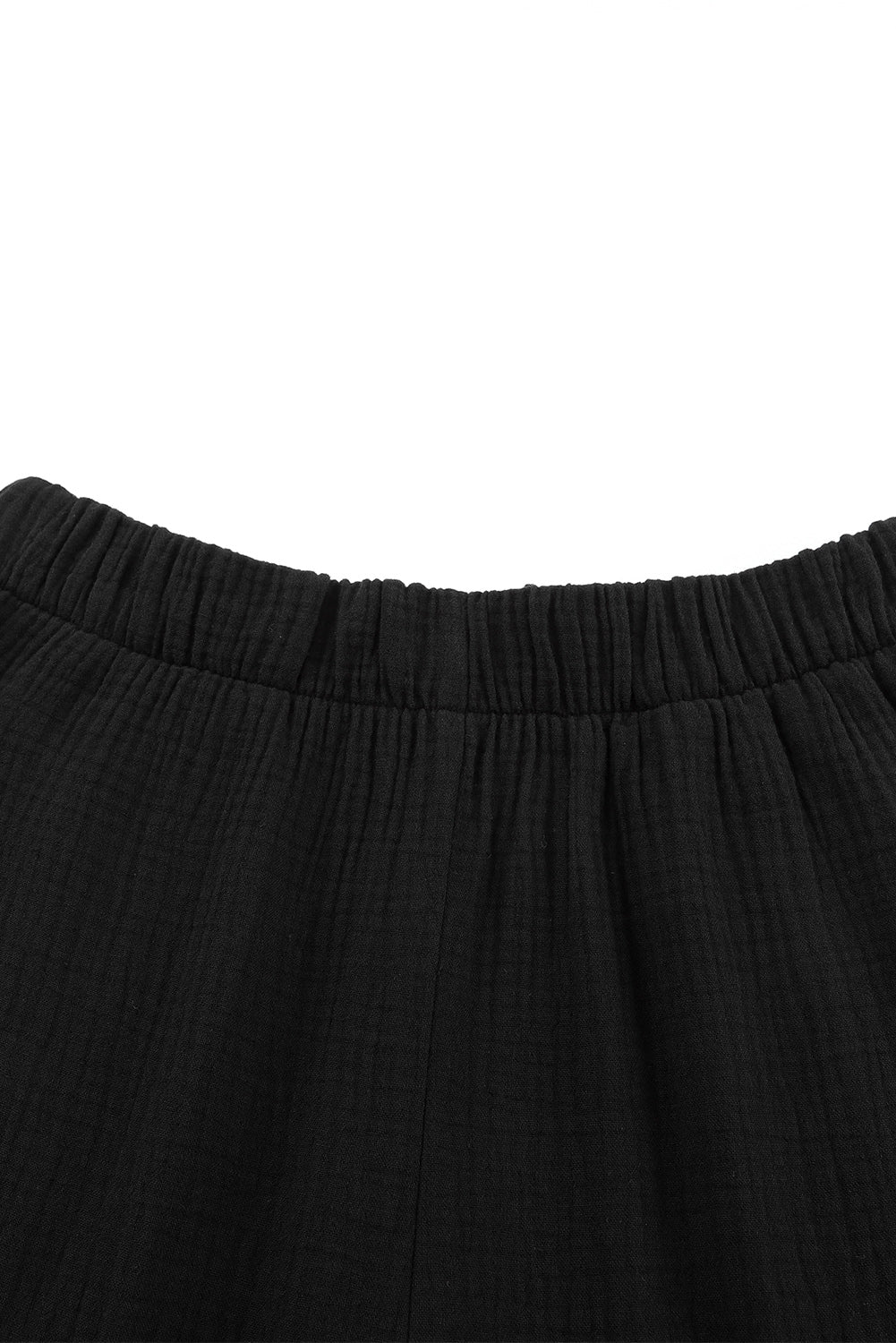 Schwarze strukturierte hose mit hoher taille und gerafftem glockenboden