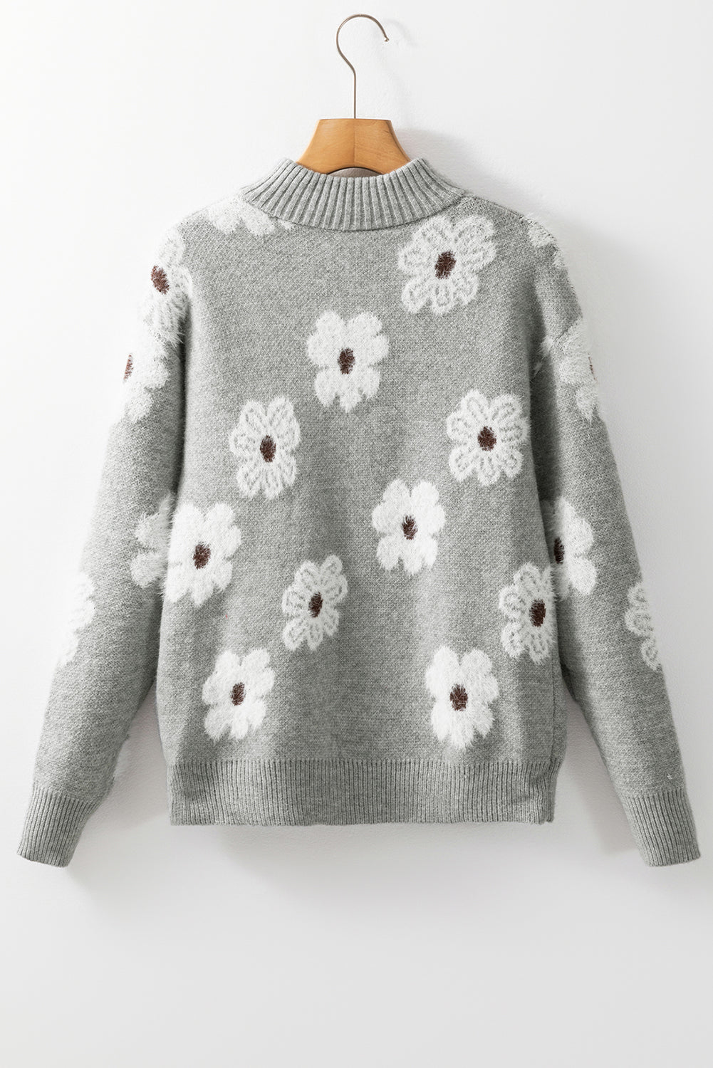 Grauer pullover mit floralem muster und halbem reißverschluss an der schulter