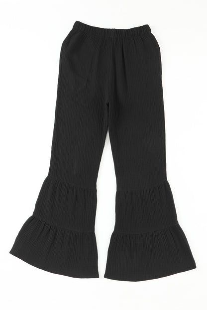Schwarze strukturierte hose mit hoher taille und gerafftem glockenboden
