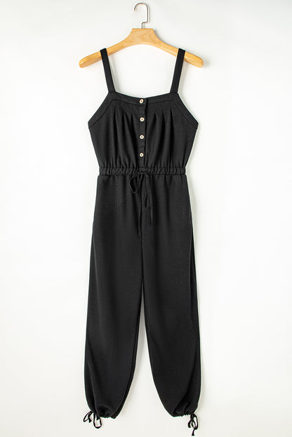 Schwarzer jumpsuit mit geknoteten trägern und strukturiertem kordelzug