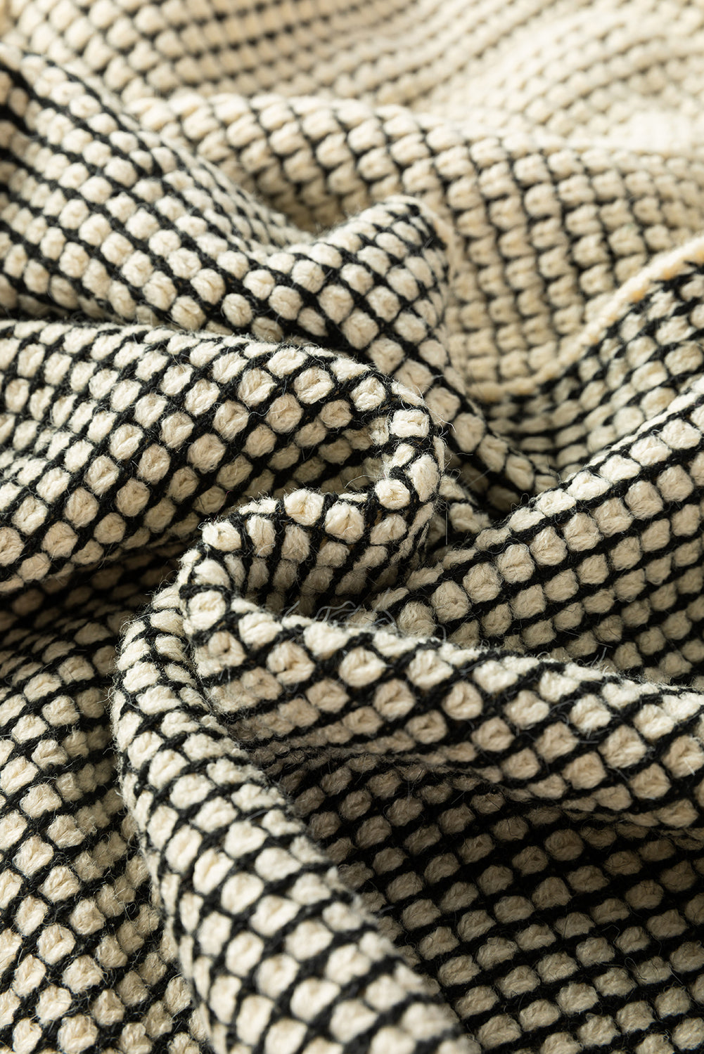 Aprikosenfarbene karierte strickjacke mit kontrastbesatz und offener vorderseite