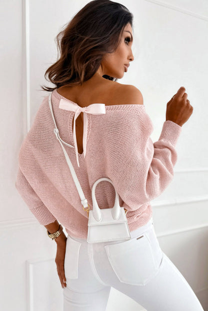 Pullover mit rosa schleifenknoten und dolman-ärmeln