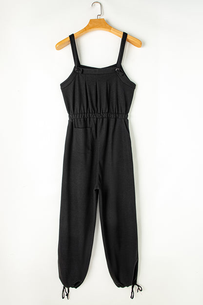 Schwarzer jumpsuit mit geknoteten trägern und strukturiertem kordelzug