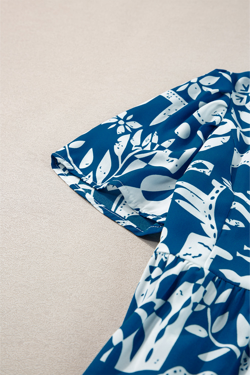 Blaues Kleid mit geteiltem Halsausschnitt und Rüschenbesatz mit Blumenmuster