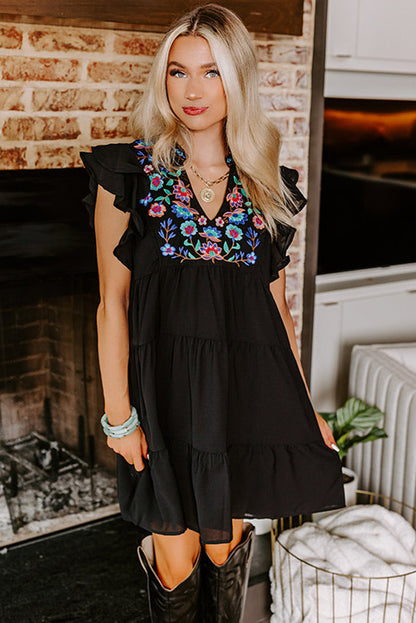 Schwarzes, mit blumen besticktes, gerafftes minikleid
